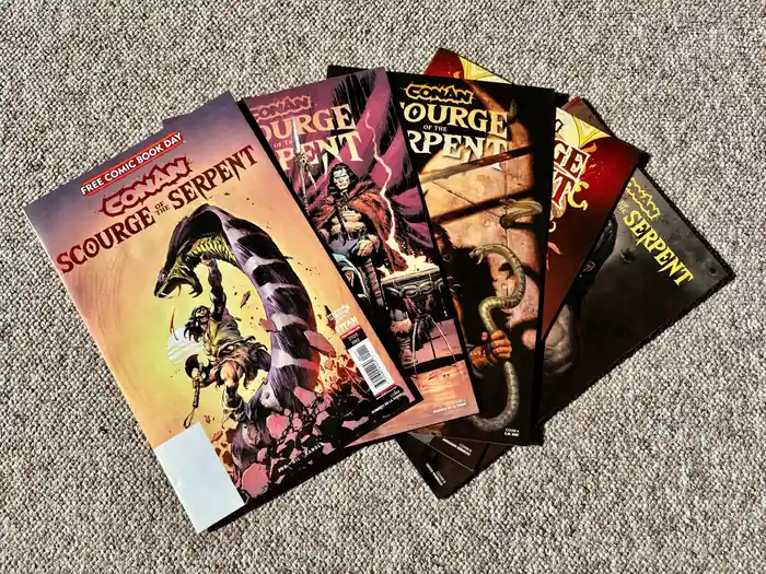 Collection of Conan Scourge of the Serpent comic covers arranged on carpet